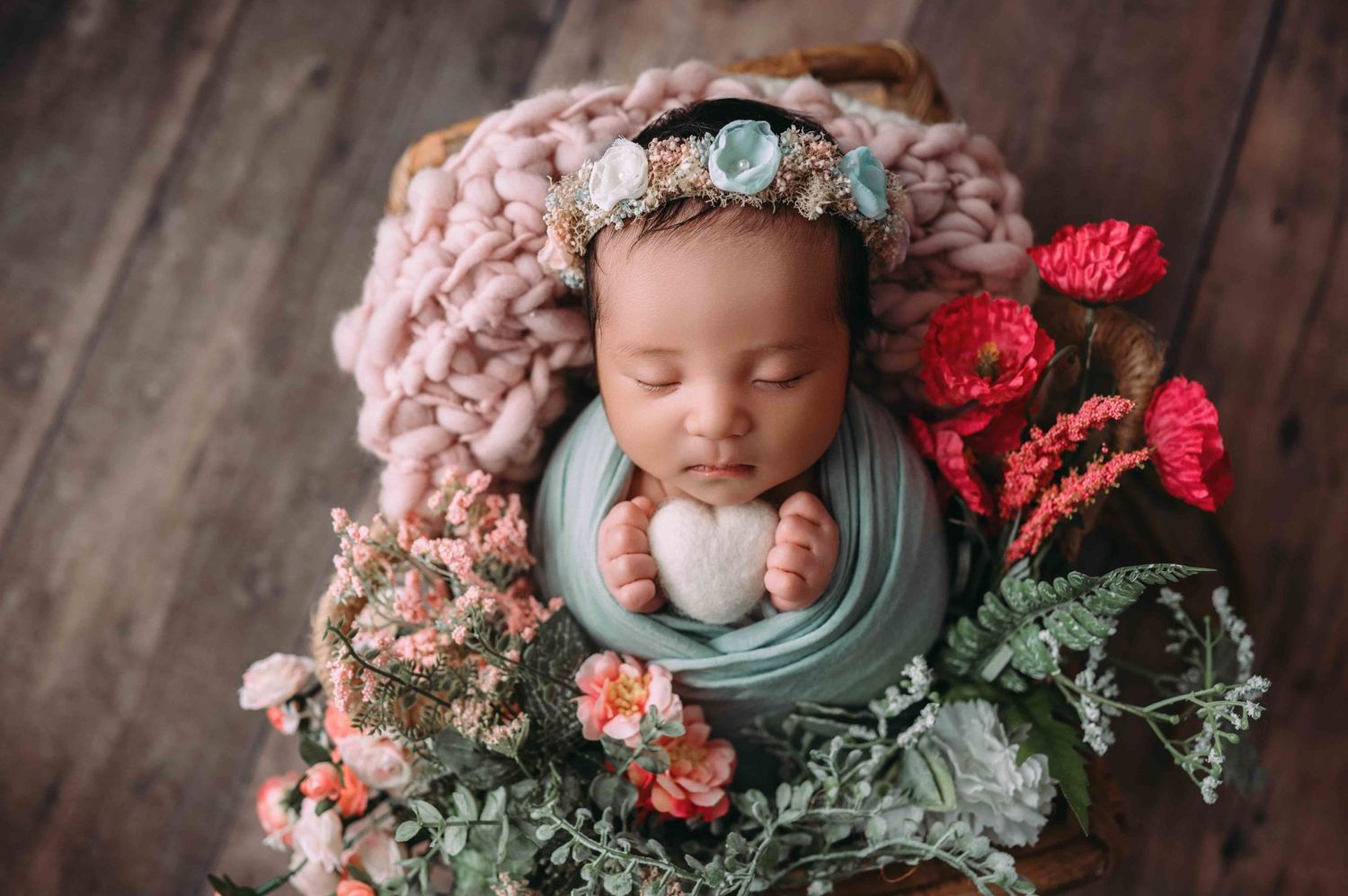Newborn baby girl in flower headband captured during custom session in Woodbury, MN
