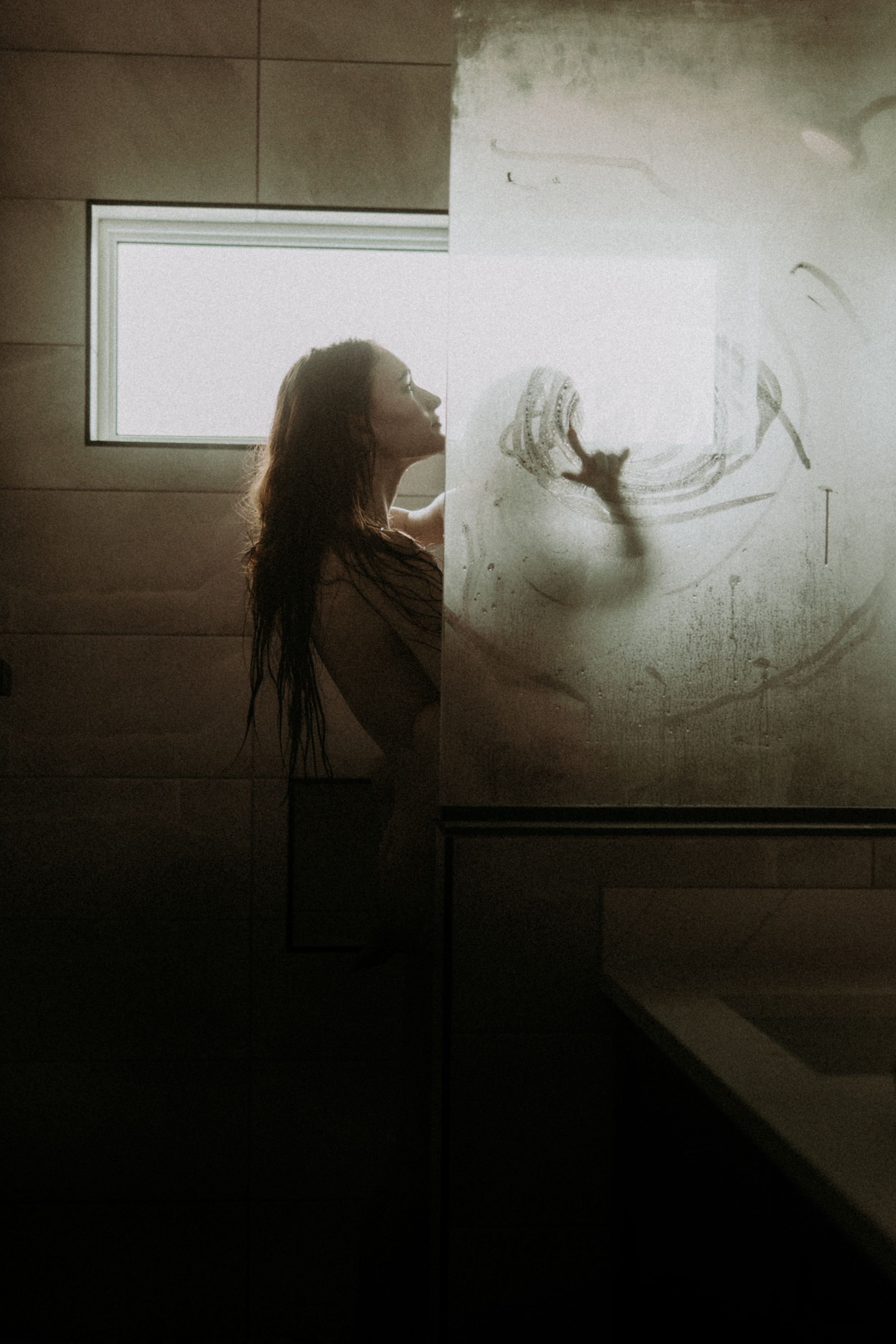 A dark and moody sequence showing a silhouette interacting with shadow art on a dimly lit wall.