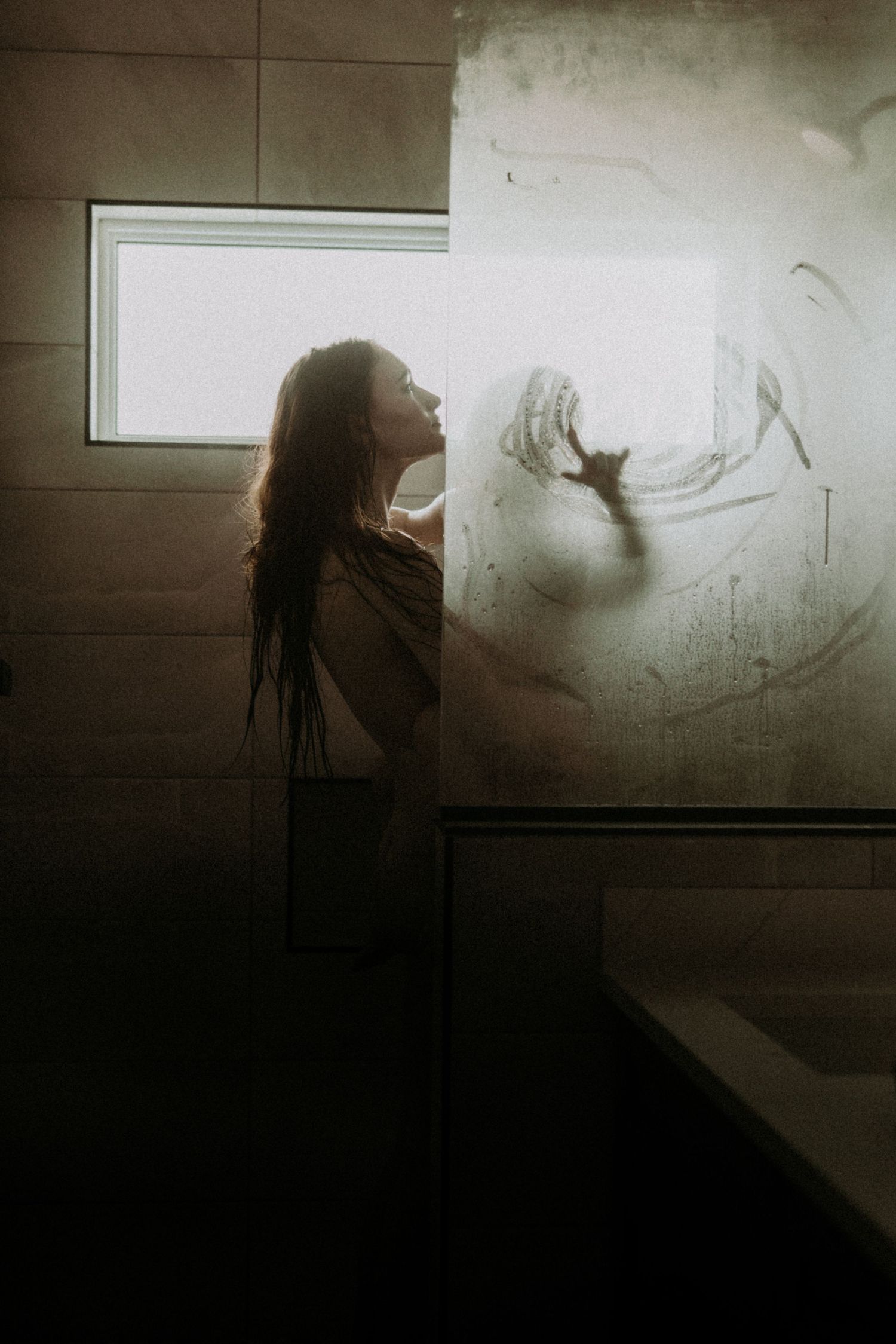 A dark and moody sequence showing a silhouette interacting with shadow art on a dimly lit wall.