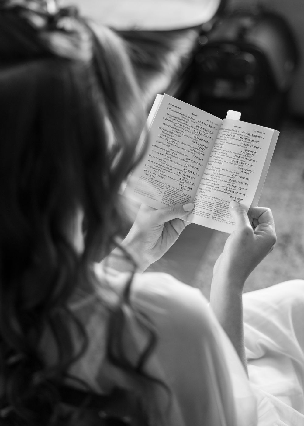 A person reading a book or letter while lying down, shown in multiple black and white frames in a collage style.