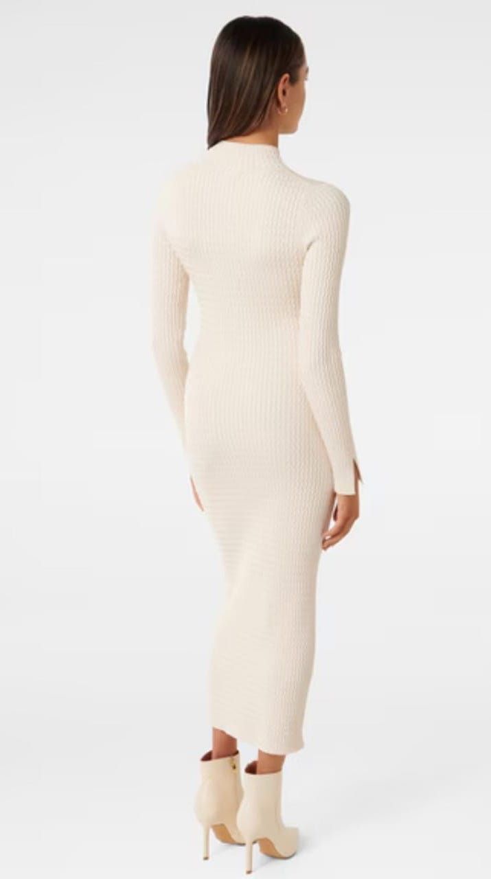 Elegant cream ribbed bodycon dress shown from the back with ankle boots.