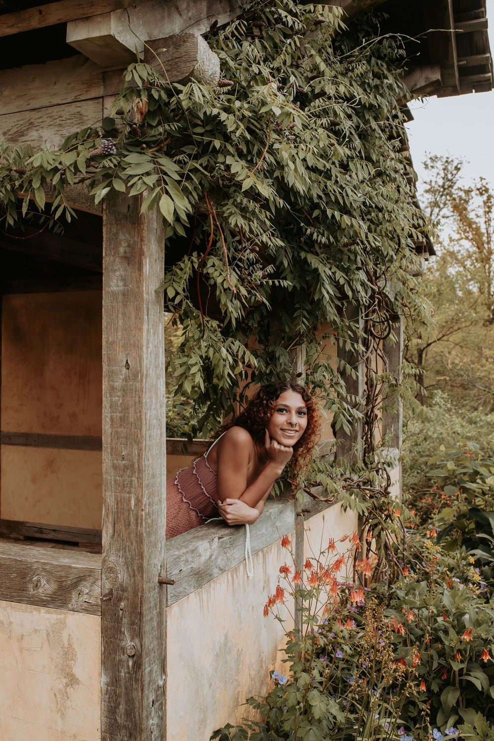 Vines and foliage frame a rustic architectural setting in a series of atmospheric outdoor shots.