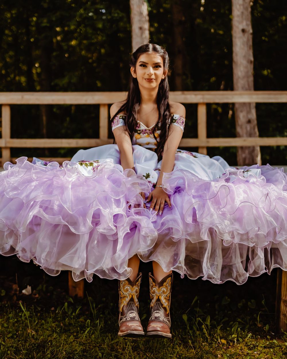 Purple ruffled dress paired with cowboy boots for unique forest photo session.