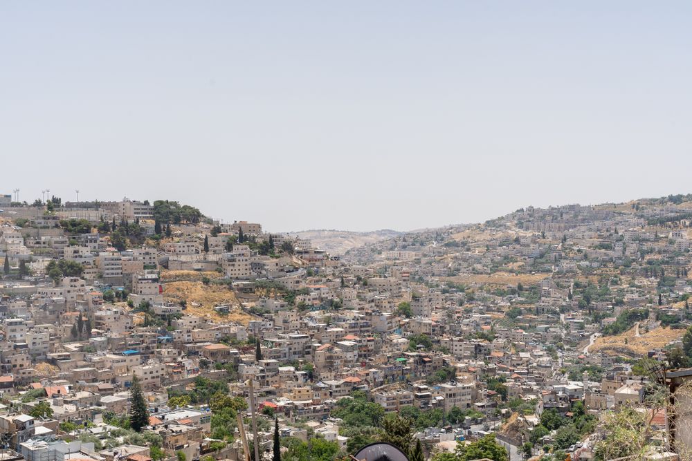 Panoramic view of densely packed hillside houses in East Jerusalem.