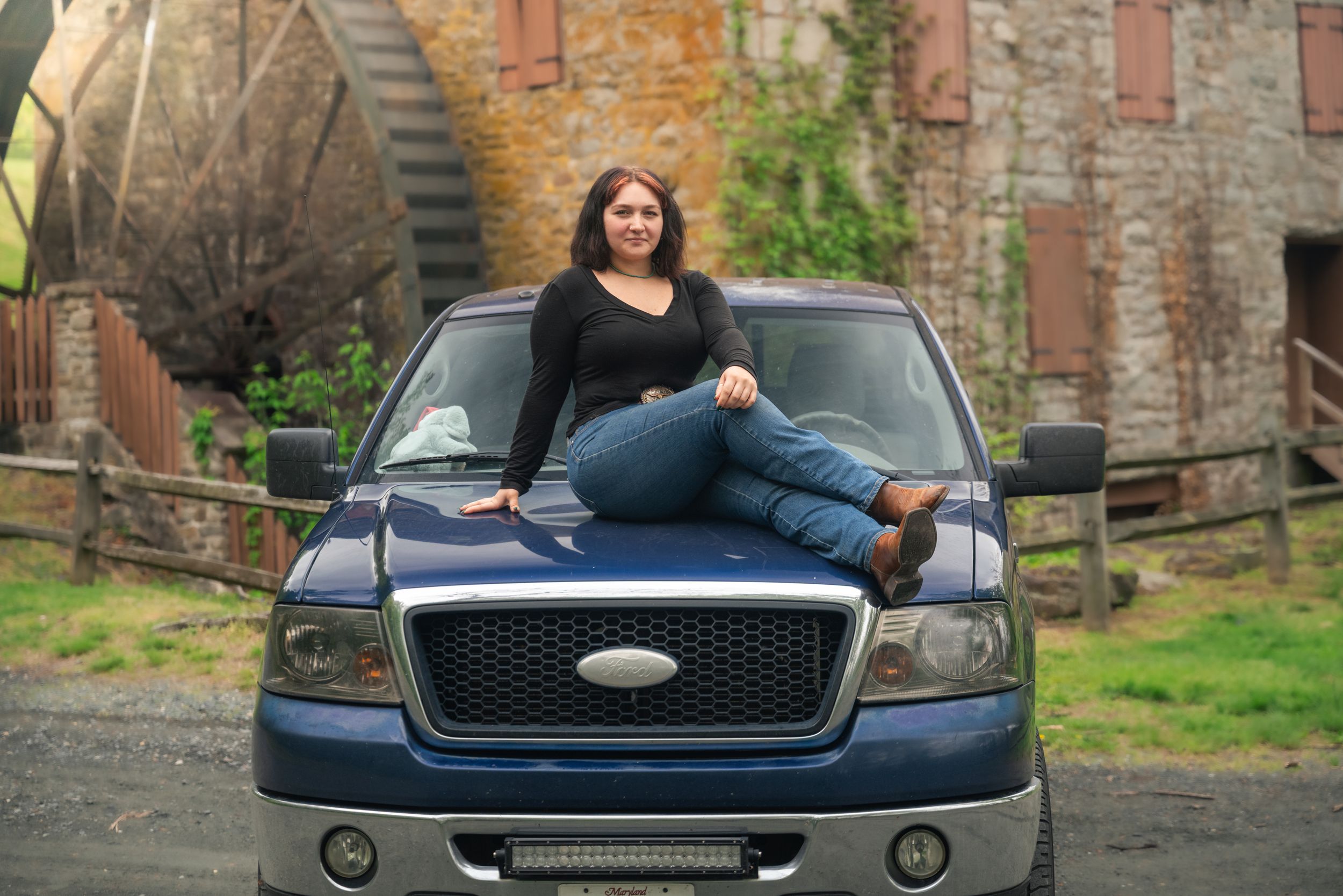 A dark blue Ford vehicle is shown from multiple angles parked in front of a brick building.