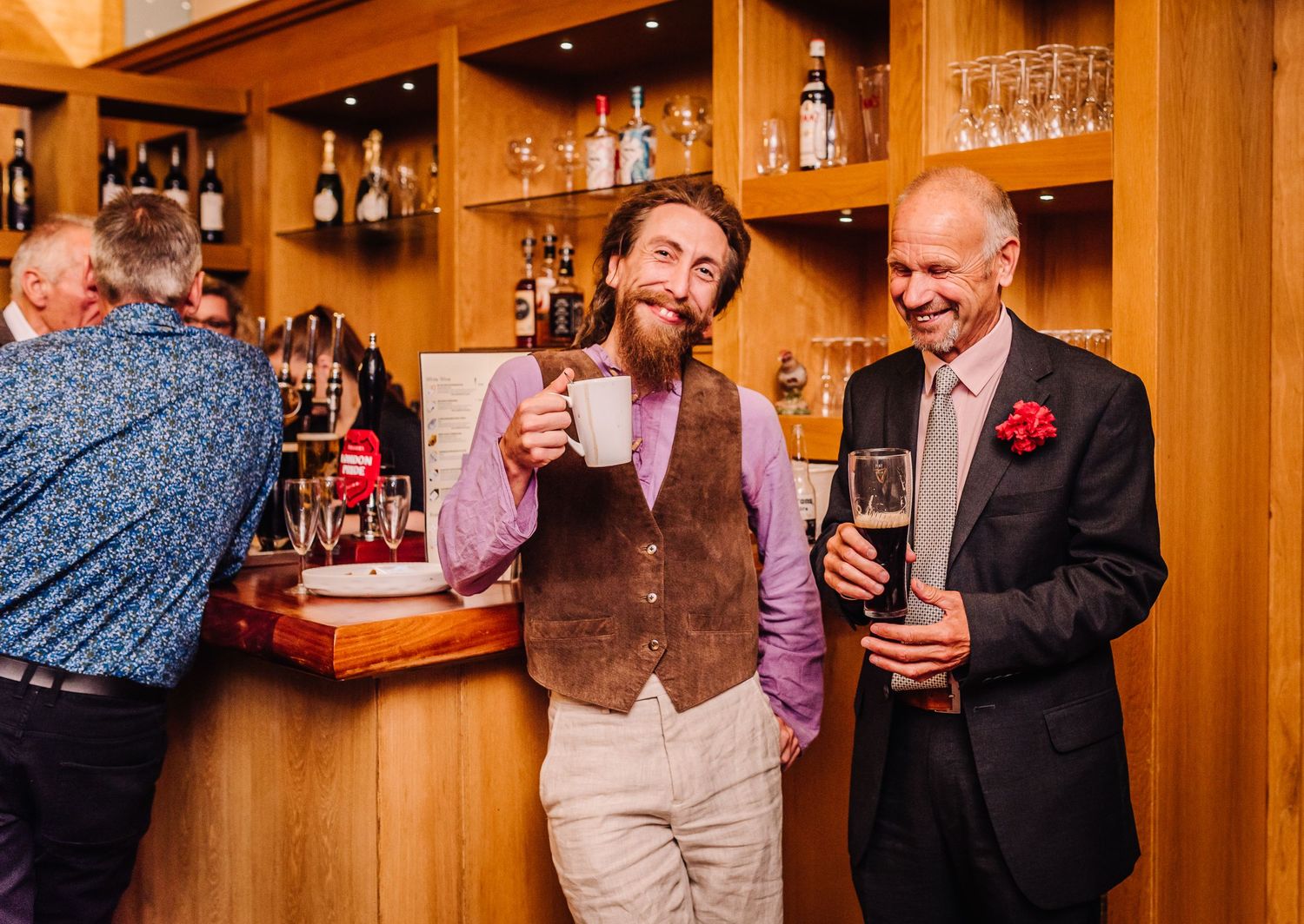 Two men enjoy a drink at Wimborne wedding venue, Oak Remedy golf club. Documentary candid  Wedding Photographer, Dorset Somerset, Devon