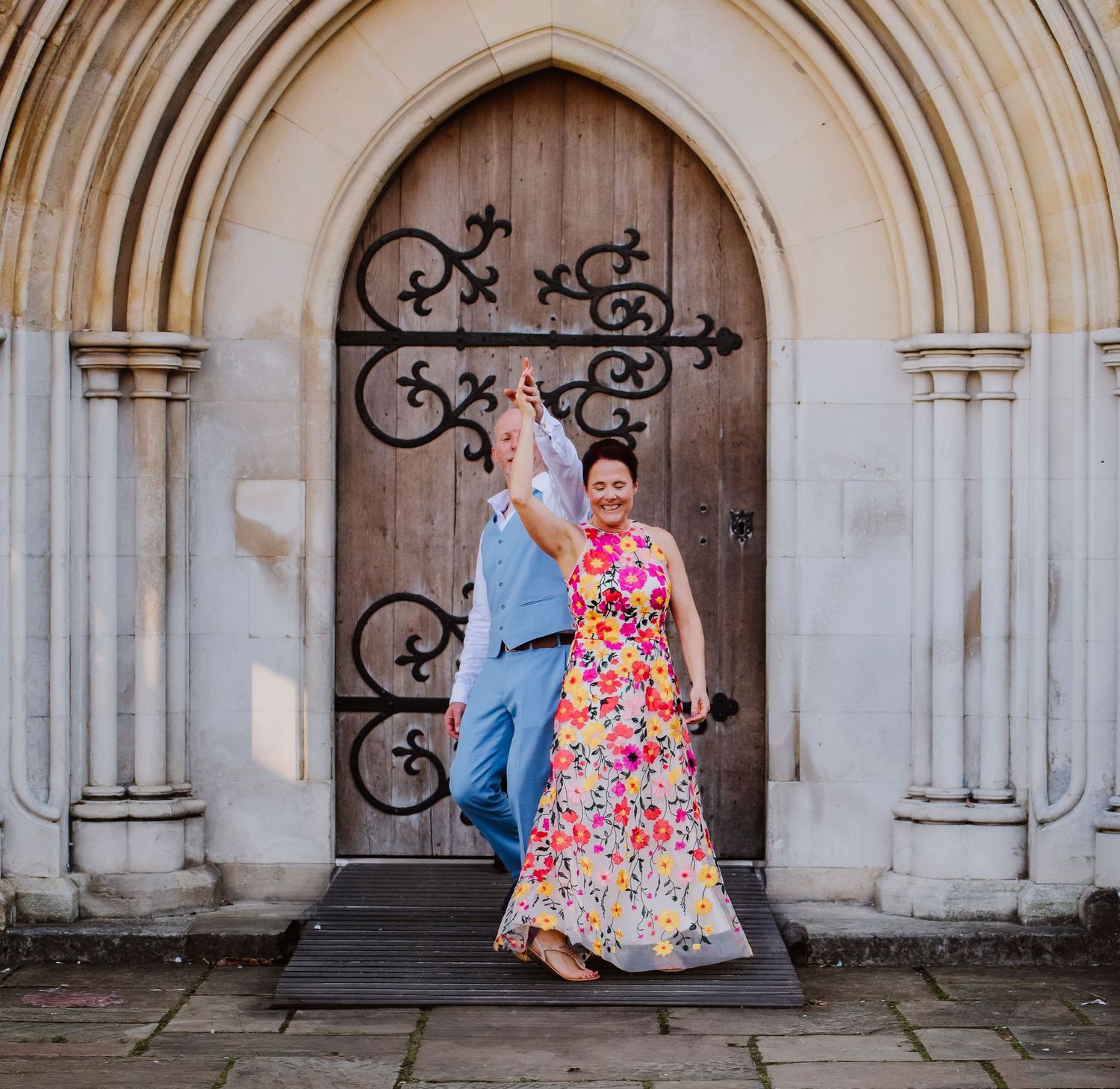 Bride in bright flower wedding dress dance at Winchester.  Documentary candid  Wedding Photography, Dorset, Hampshire, Wiltshire, Devon,