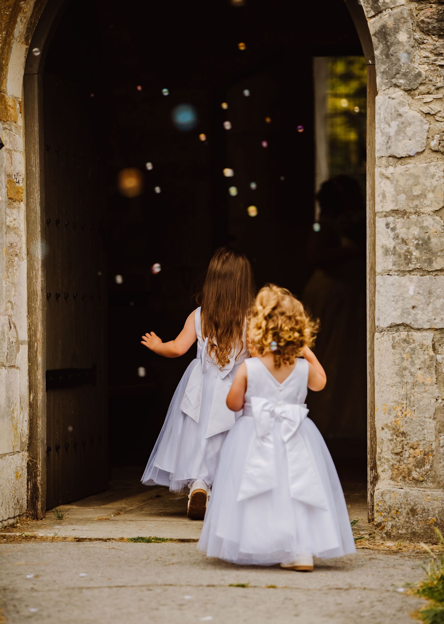 Bubbles at weddings. Dorchester church wedding.  Documentary candid  Wedding Photography, Dorchester  Dorset