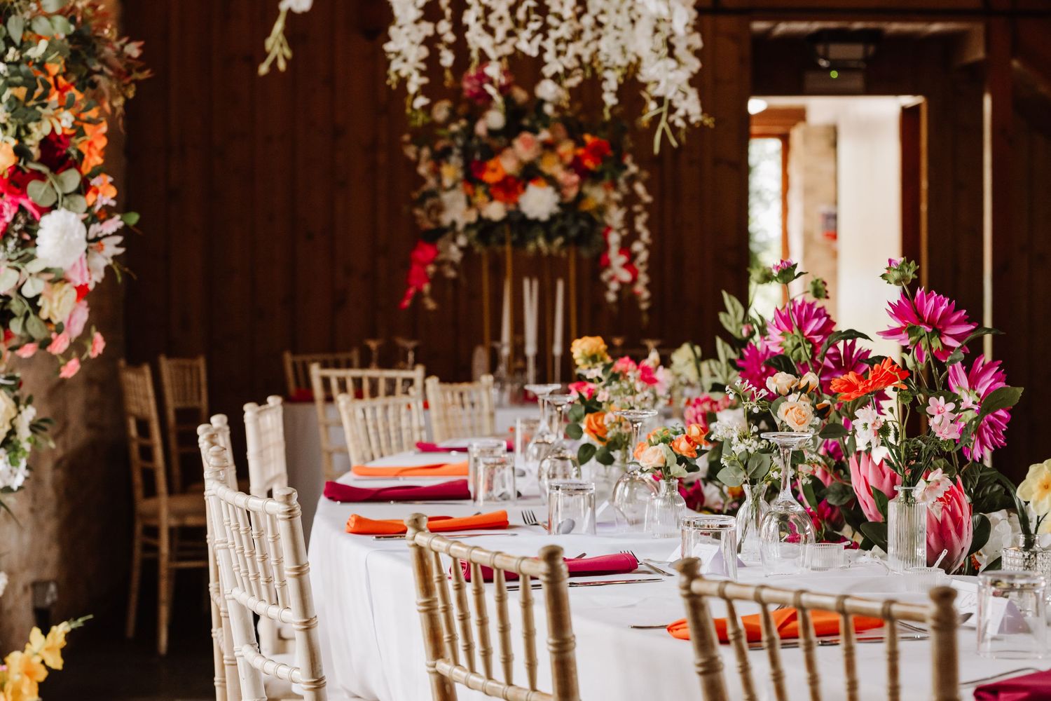 Bright artificial wedding floral display. Barn Wedding Venue Dorset - Kingston Country Courtyard Woodland wedding venue Dorset