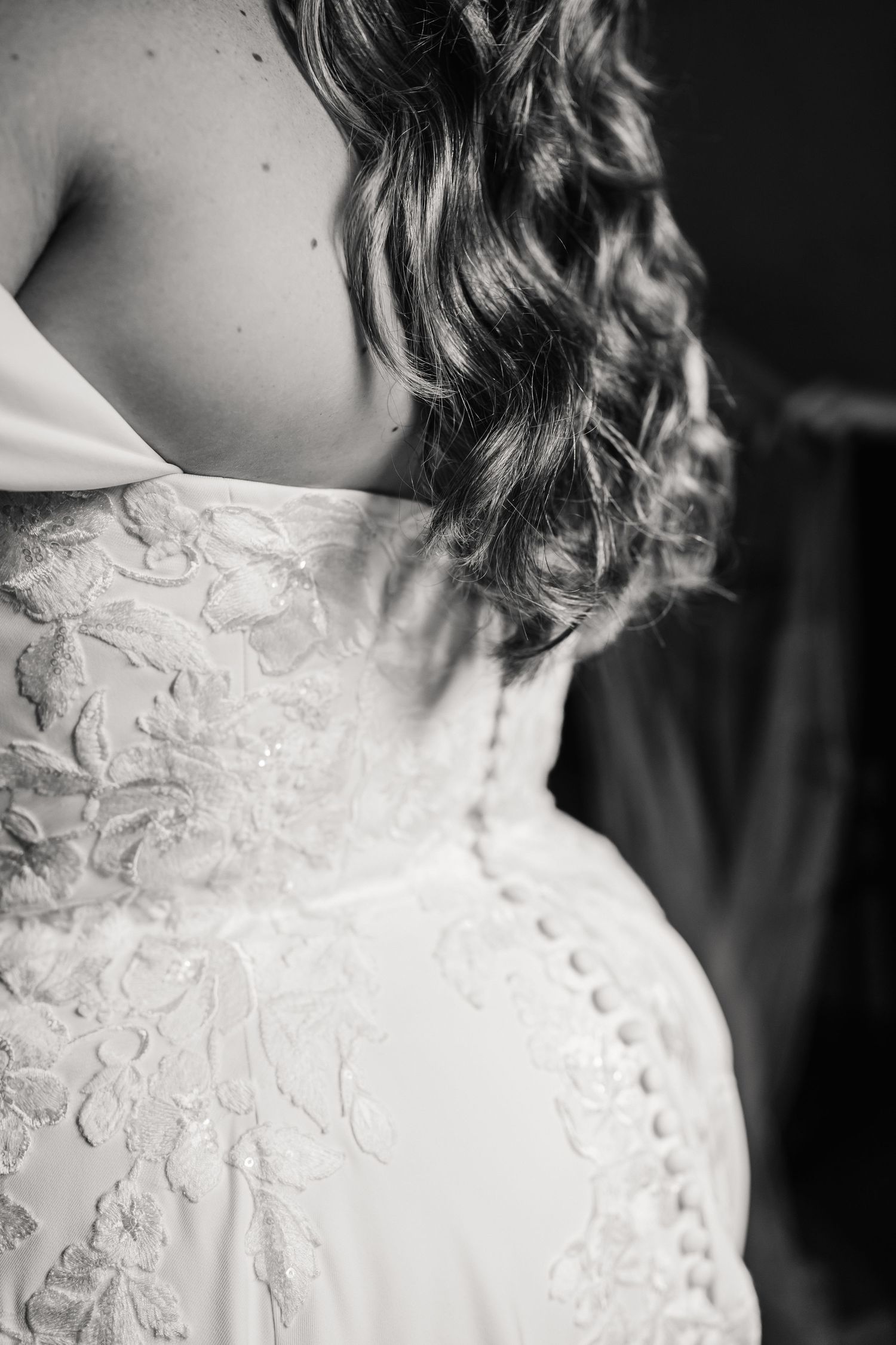 Black and white close-up of bride in strapless lace wedding dress with curly hair at Elmhay, Orchardleigh estate, Frome