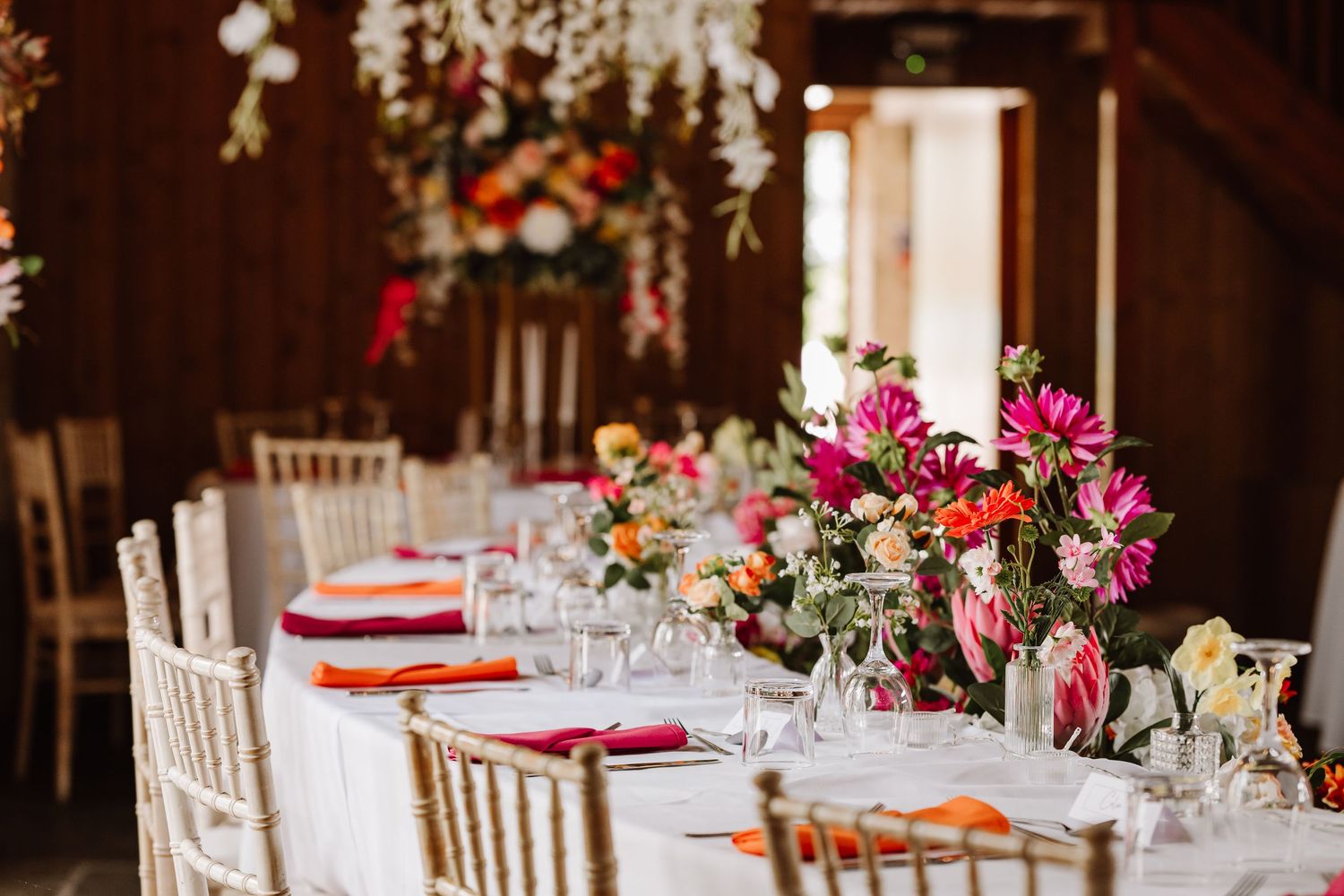 Bright artificial wedding floral display. Barn Wedding Venue Dorset - Kingston Country Courtyard Woodland wedding venue Dorset