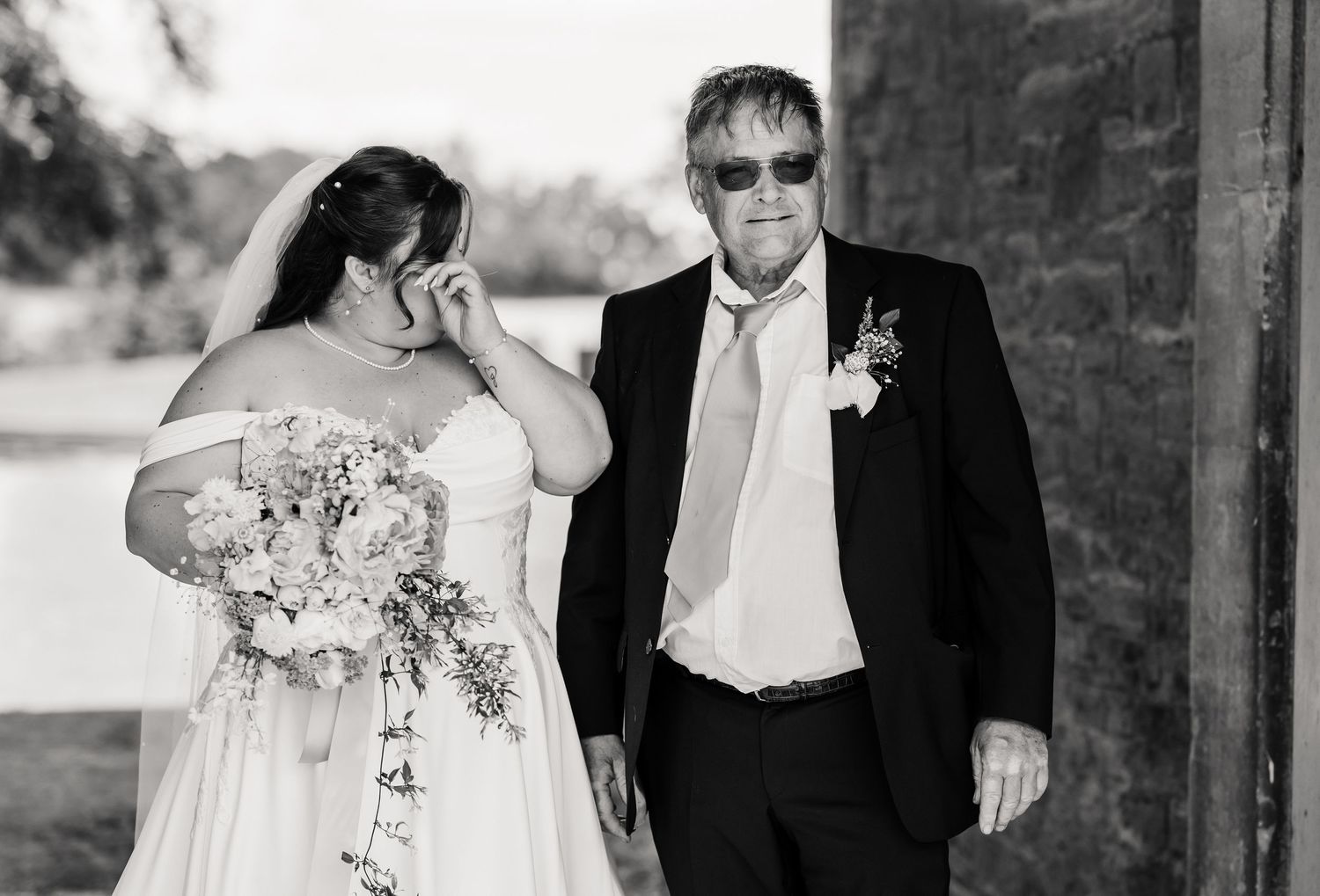 Bride and her father walking together in black and white photo before wedding ceremony at Elmhay, Orchardleigh estate, Frome