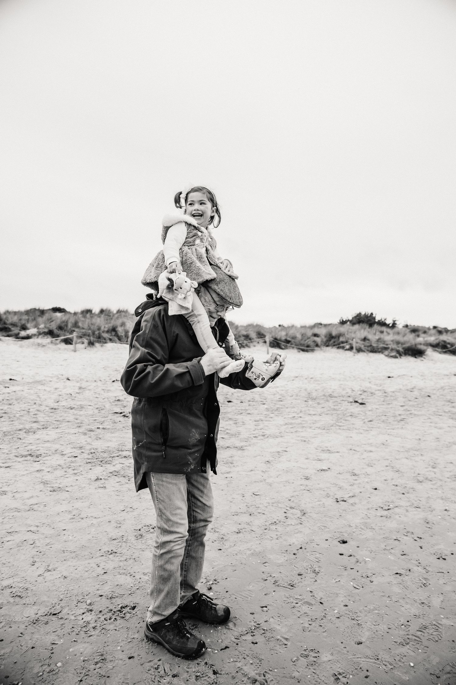 Grandfather and Granddaughter on Studland, Dorset Beach. Candid documentary family photography. Candid family photography Dorset.