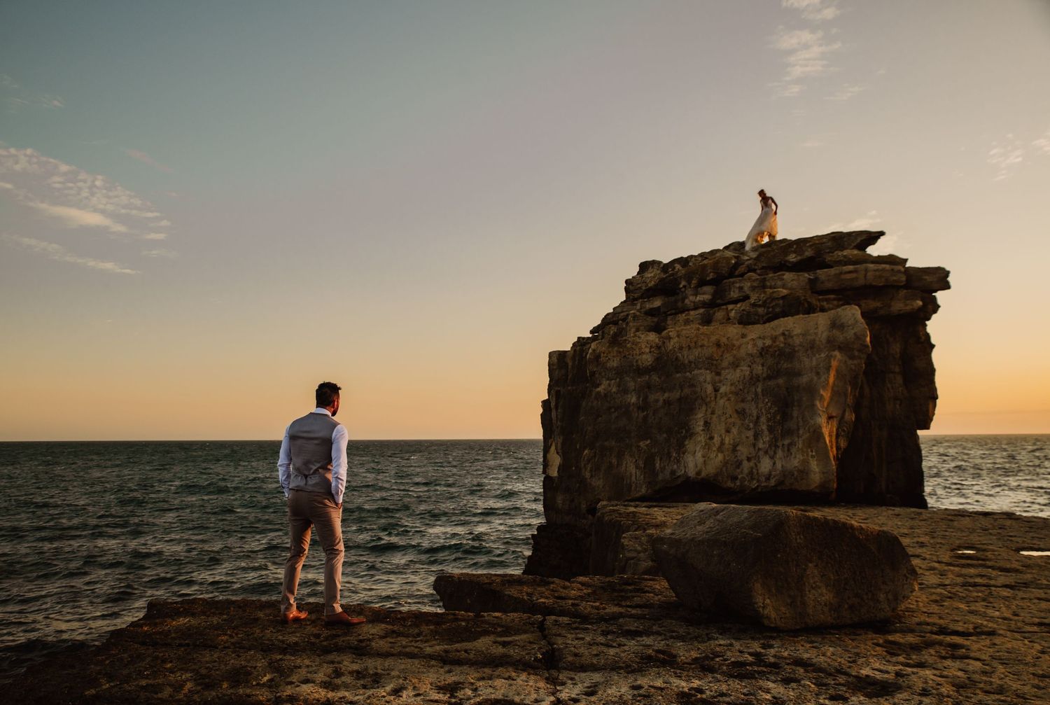 Portland, Dorset, Wedding photography. Bride on top of Pulpit Rock at sunset. Documentary candid travel photographer Devon, Somerset,