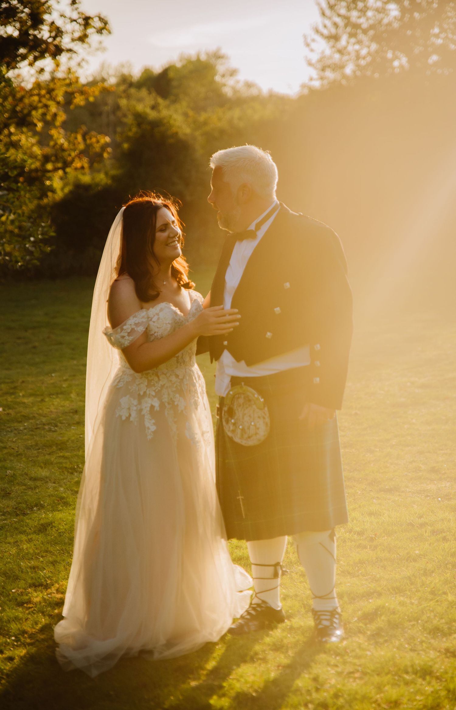 Groom in kilt and Bride during golden hour at the Grey Manor Hotel, Cholderton, Salisbury. Documentary candid  Wedding Photography, Dorset.
