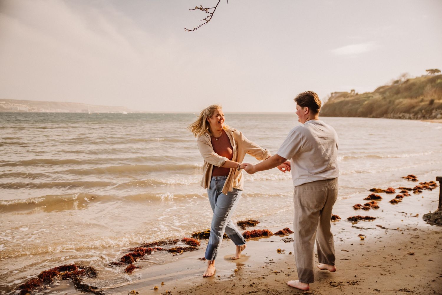 Playful engagement shoot on a beach in weymouth Documentary candid  Wedding Photographer, Dorset Somerset, Devon