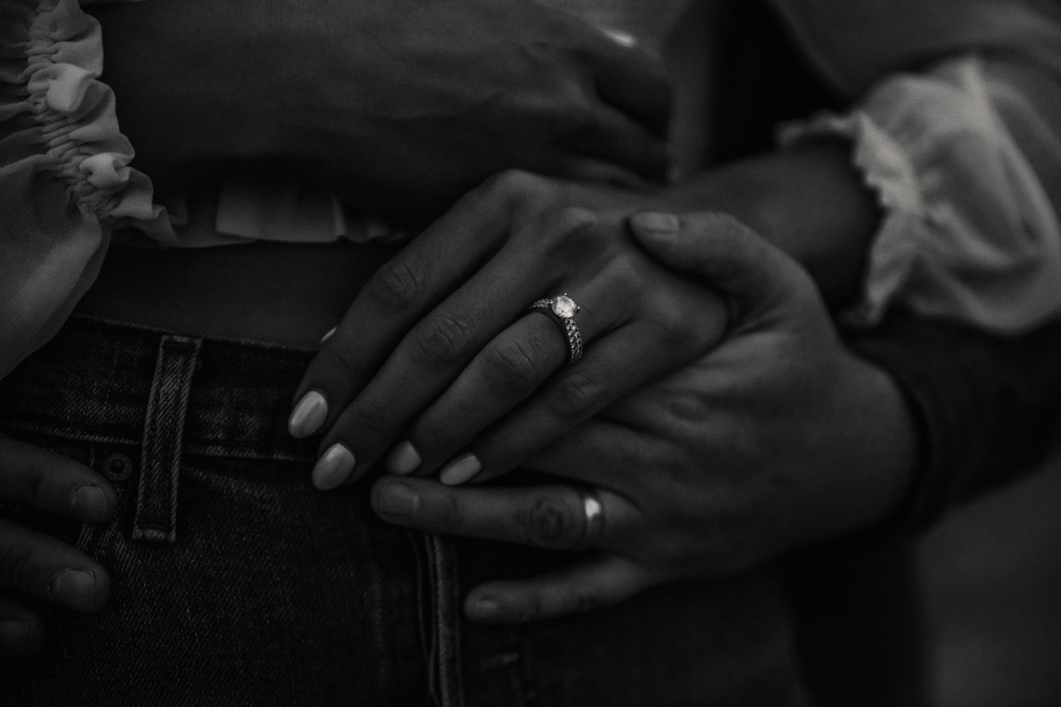 Anniversary shoot. Close up of hands and rings. Photo is in black and white. Engagement shoot on beach. Weymouth photographer