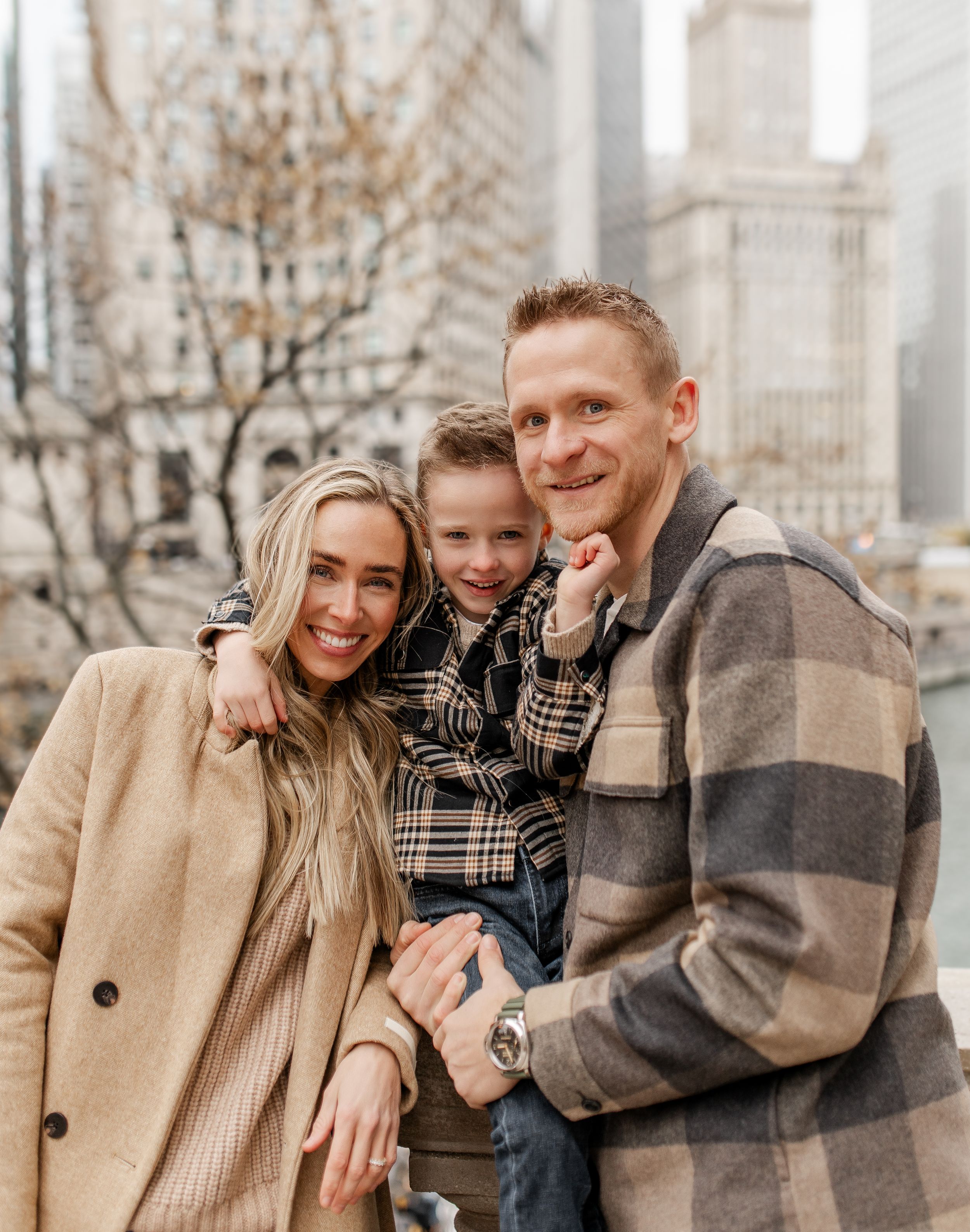 Candid family portrait with Chicago's impressive architectural skyline as backdrop.