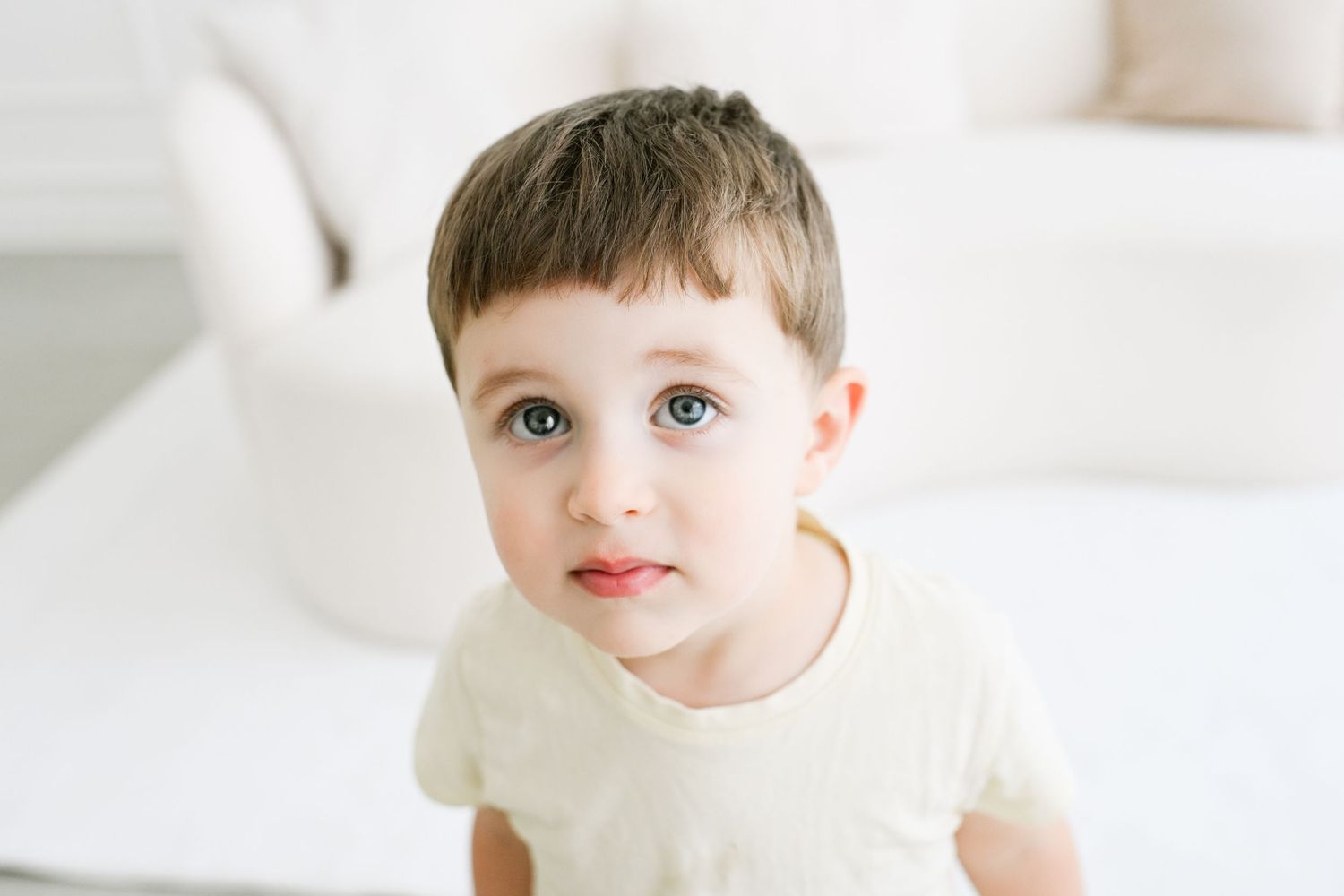 Close-up studio portraits on white background showing playful expressions.
