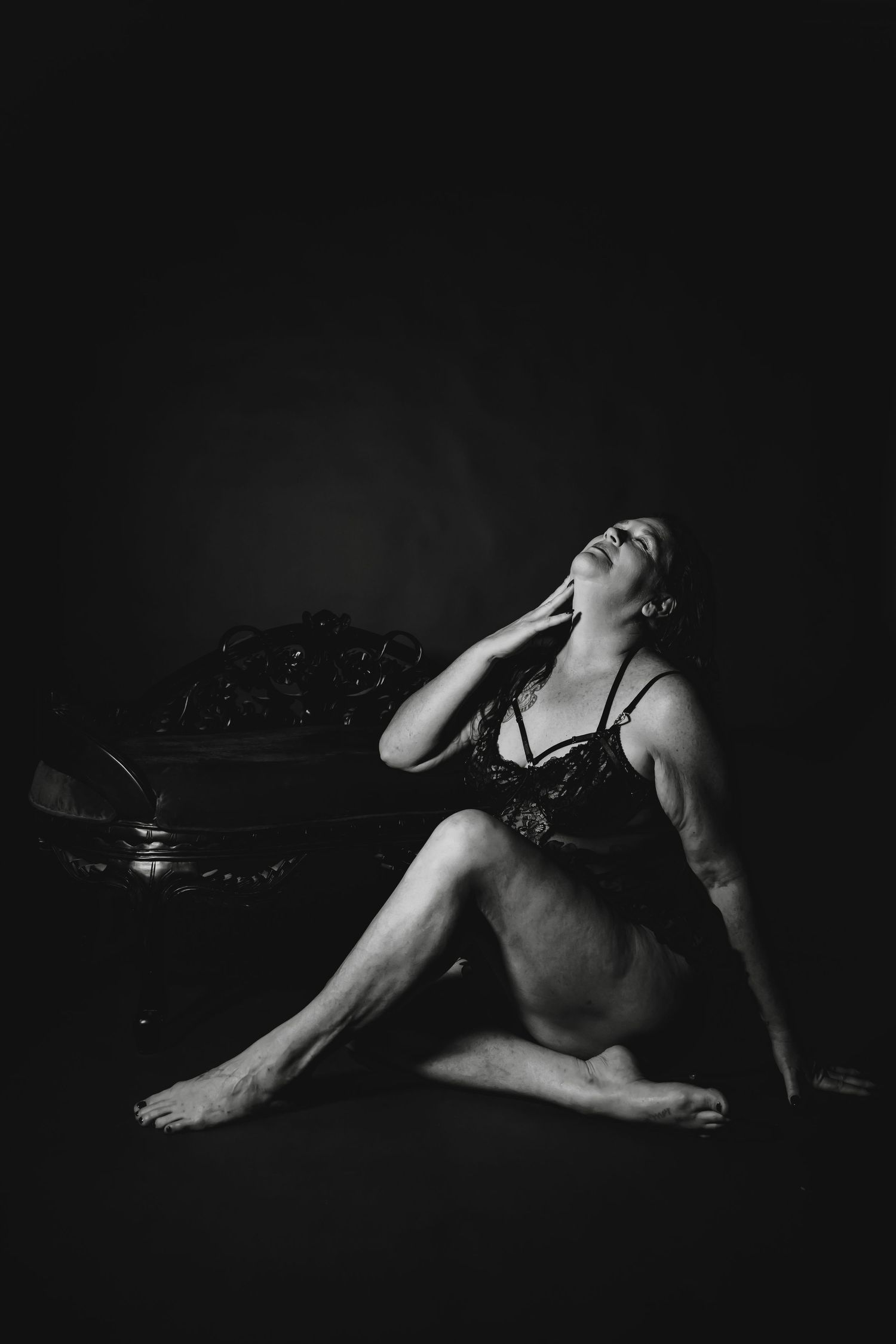 Intimate candlelit boudoir portraits featuring black lace lingerie in dramatic low-key lighting.