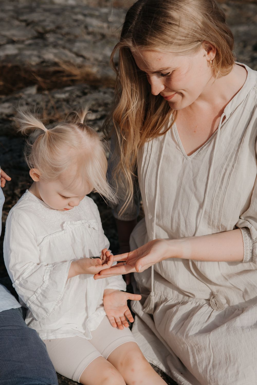 An intimate moment shared between parent and child sitting together outdoors.