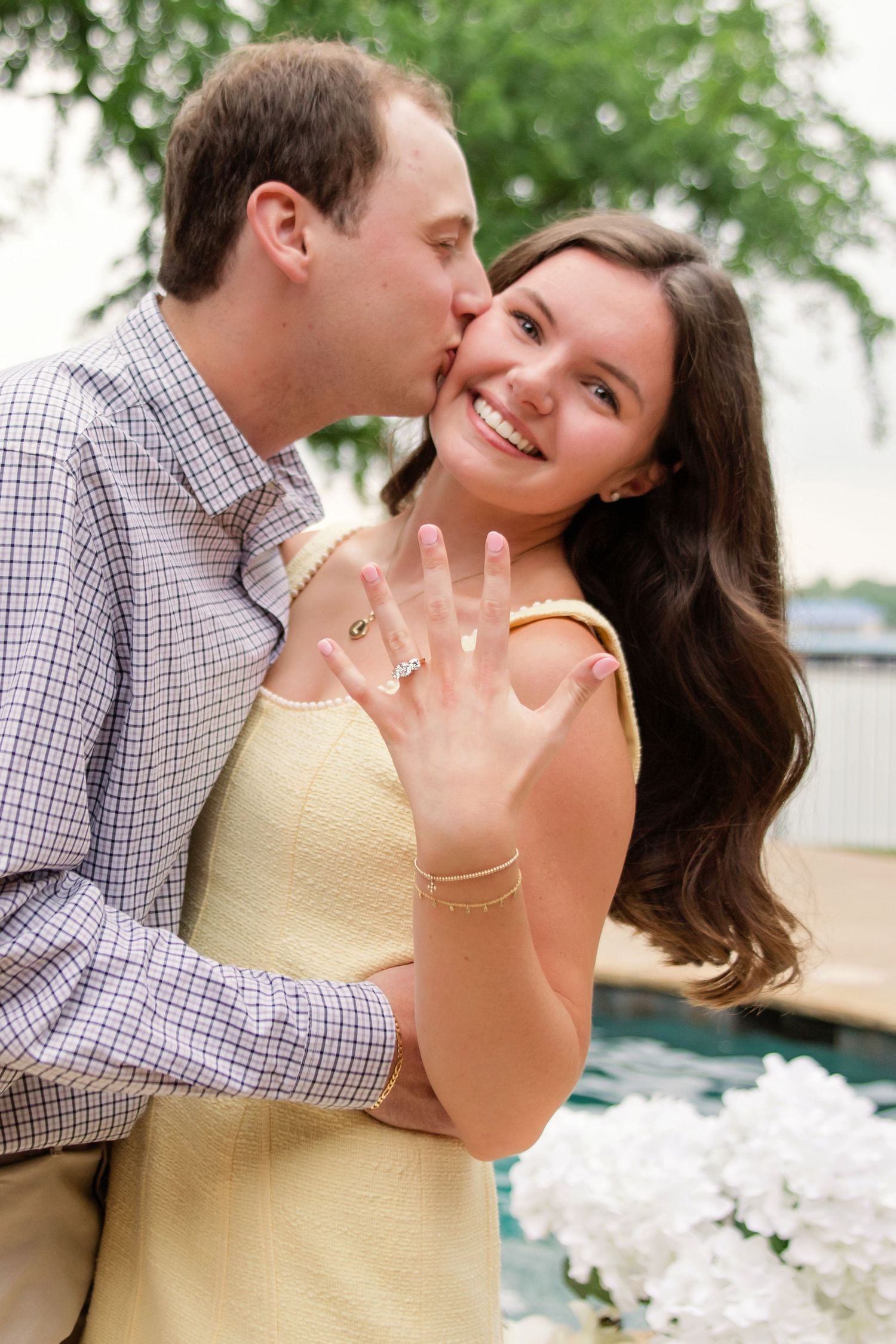 newly engaged couple showing off engagement ring for photos near Eagle Mountain Lake in Fort Worth