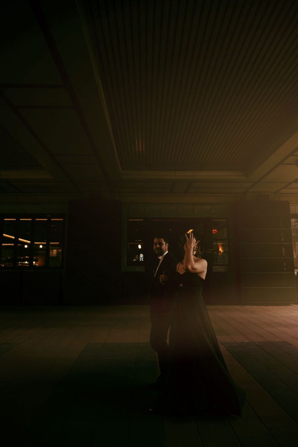 A couple shares an intimate dance in a romantic moody atmosphere.