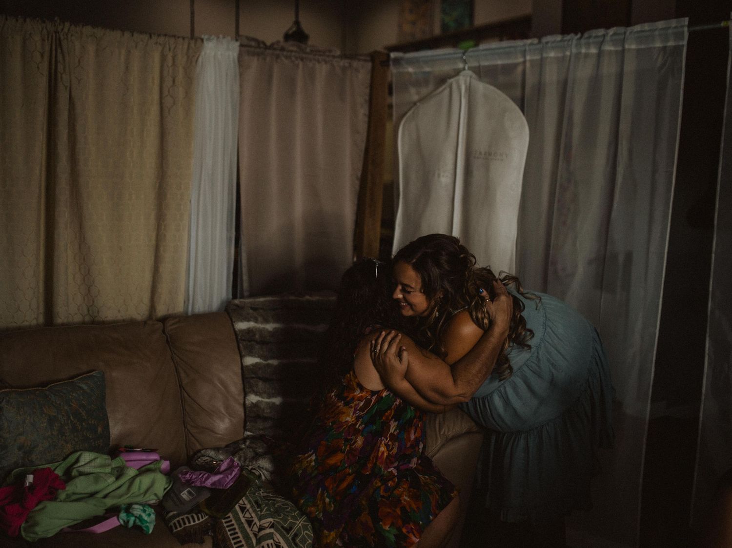 Dimly lit interior scene with white curtains and vintage furniture.