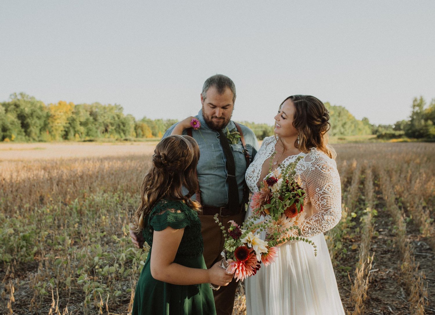 Wedding celebration in a rustic outdoor setting with colorful fall flowers.