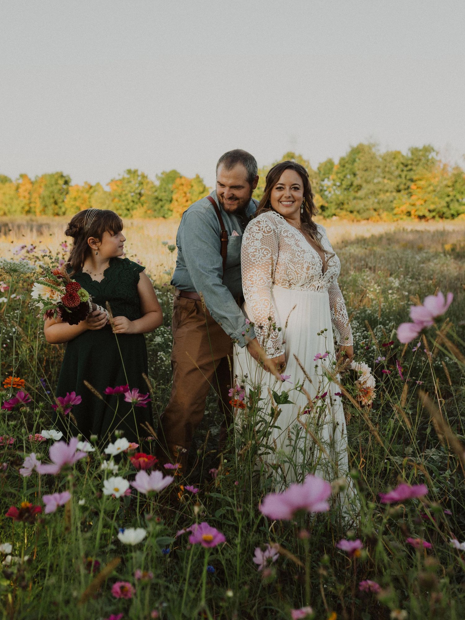 Joyful moments captured in a wildflower field with cosmos flowers blooming in the foreground.