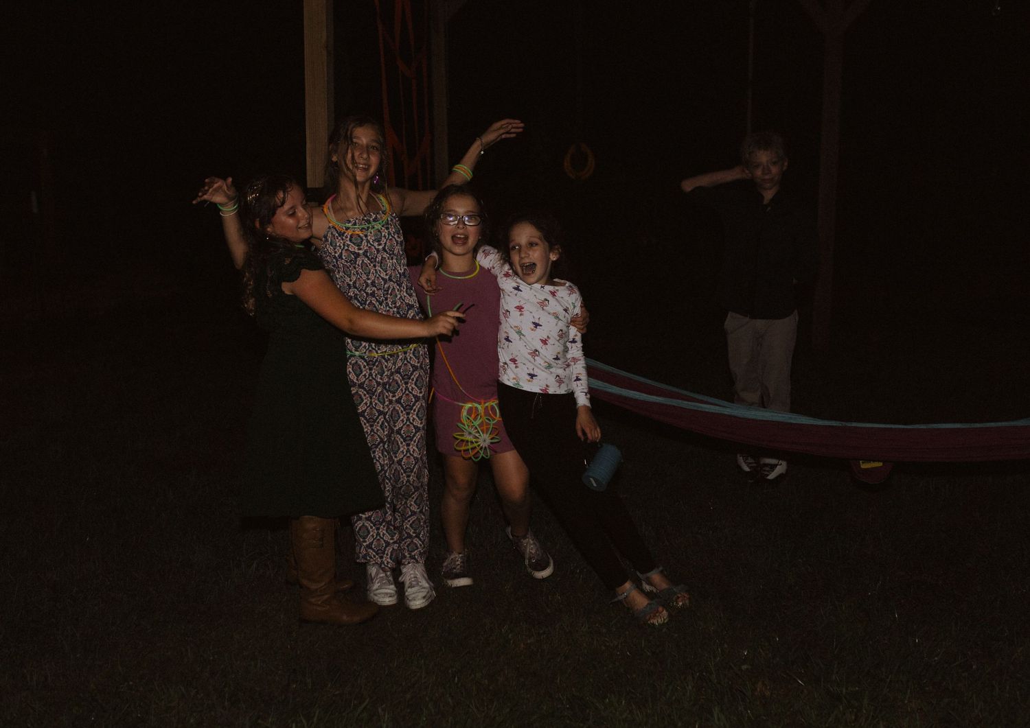 People enjoy nighttime festivities and games at an outdoor celebration.