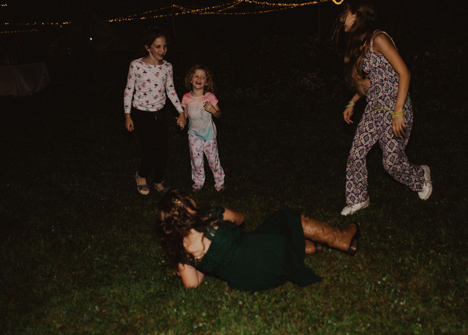 Guests enjoying themselves on a dance floor during an outdoor evening celebration.