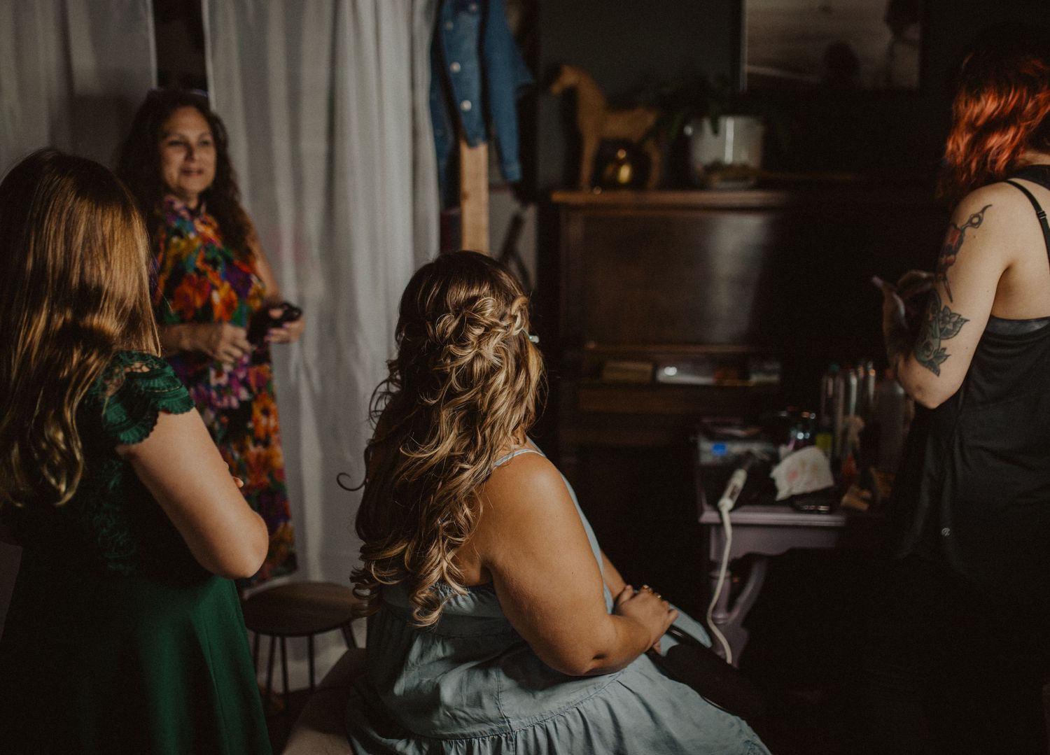 Getting ready scene in a room with white curtains and vintage decor.