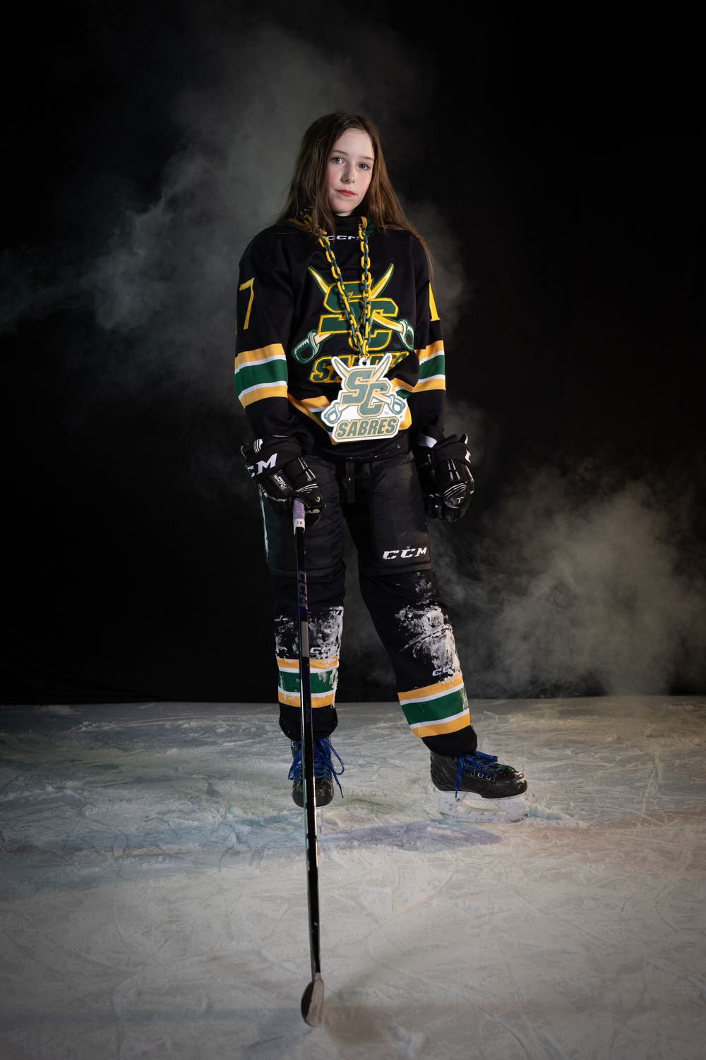 Stoney Creek Sabres Girls hockey player posing during on ice portrait session in Stoney Creek