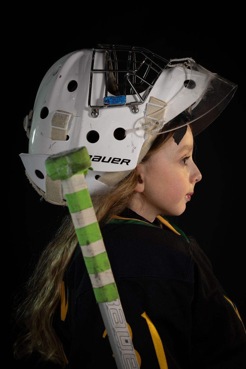 Stoney Creek Sabres Girls hockey goalie posing during on ice portrait session in Stoney Creek