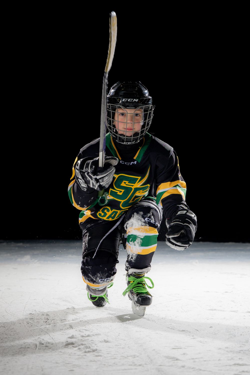 Stoney Creek Sabres Girls hockey player posing for a celly during on ice portrait session in Stoney Creek