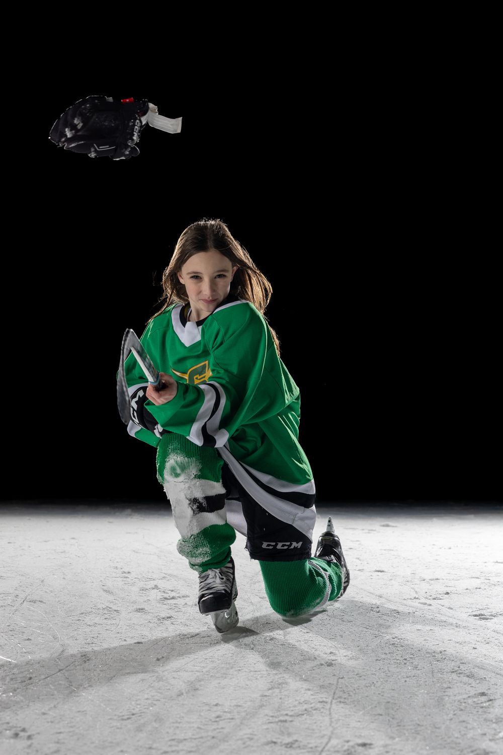 Stoney Creek Sabres Girls hockey player posing for a celly during on ice portrait session in Stoney Creek