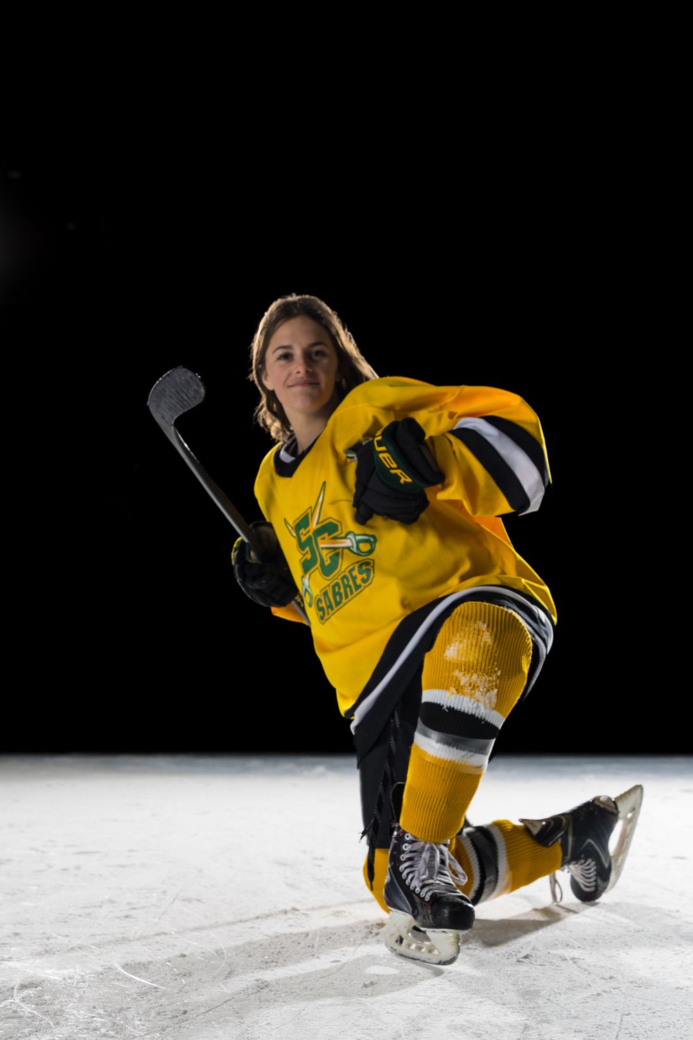 Stoney Creek Sabres Girls hockey player posing for a celly during on ice portrait session in Stoney Creek