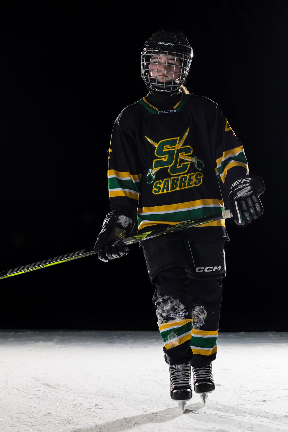 Stoney Creek Sabres Girls hockey player posing during on ice portrait session in Stoney Creek