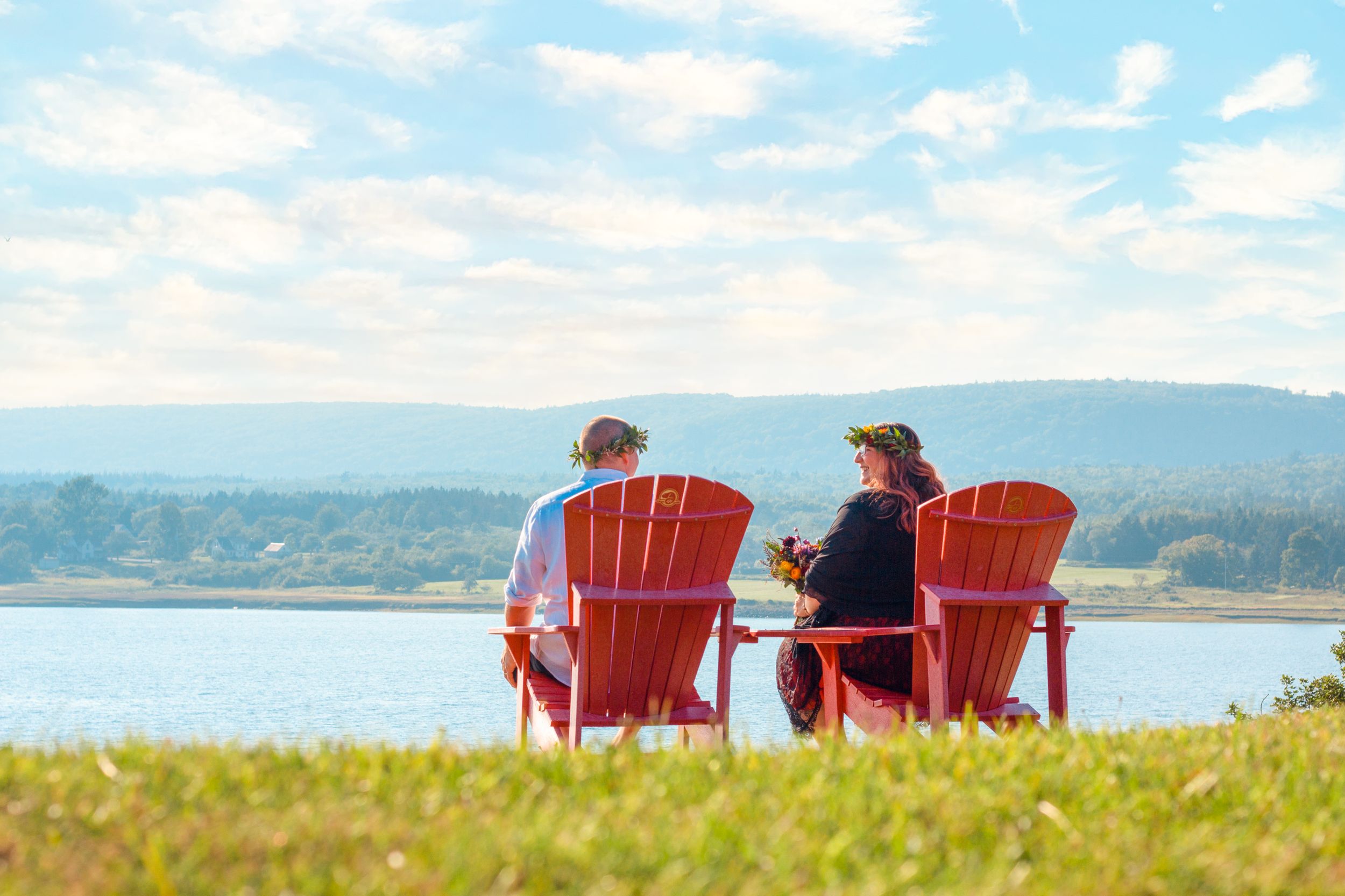 Wedding photo of bride and groom atop a hill overlooking the ocean at Fort Anne, Nova Scotia, by Daneesha Williams
