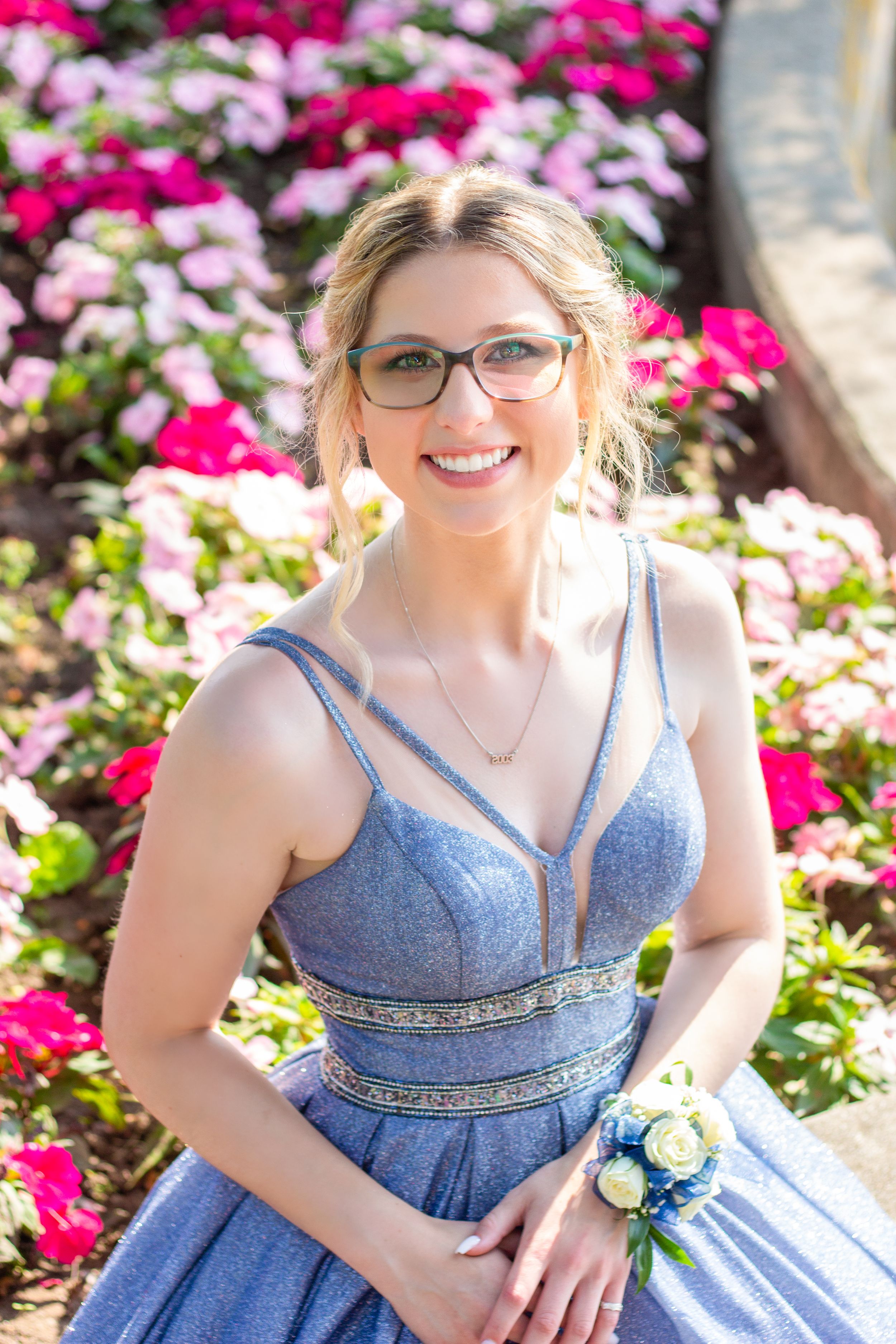 Girl in blue prom dress surrounded by beautiful pink flowers in Frost Park, Yarmouth, by Daneesha Williams