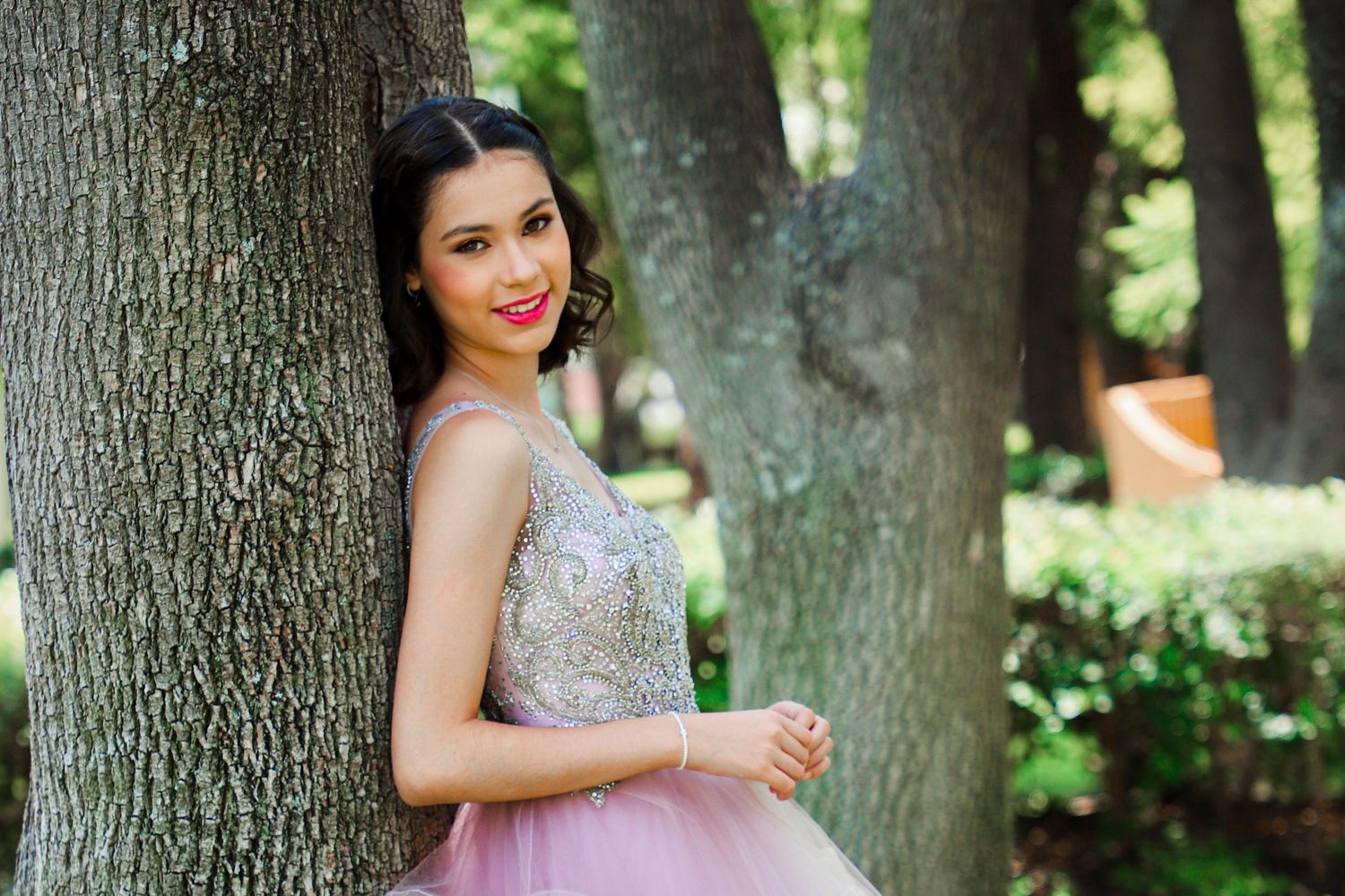 Lavender tulle dress with sparkly bodice photographed in wooded outdoor setting.