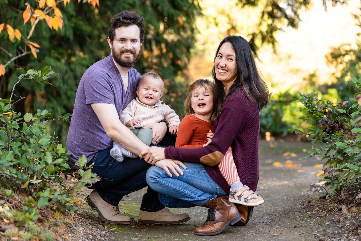 Family crouching down for a portrait in Seattle.