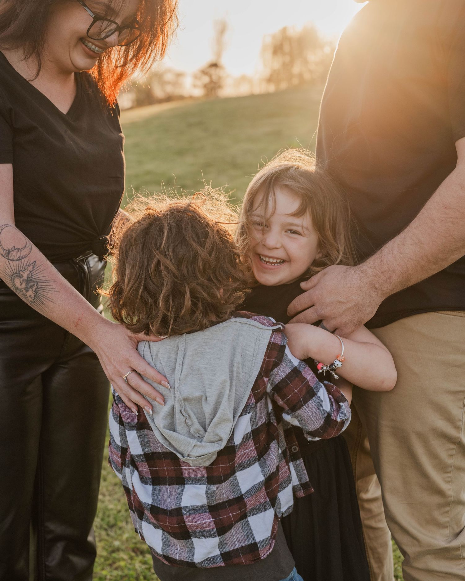 Playful family moment captured in warm sunset light showing candid interaction and movement.