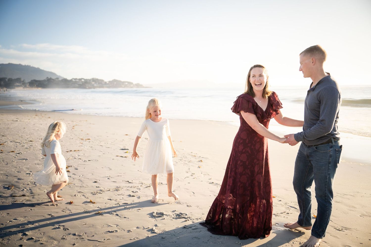 Candid family interactions during beach photoshoot at golden hour.
