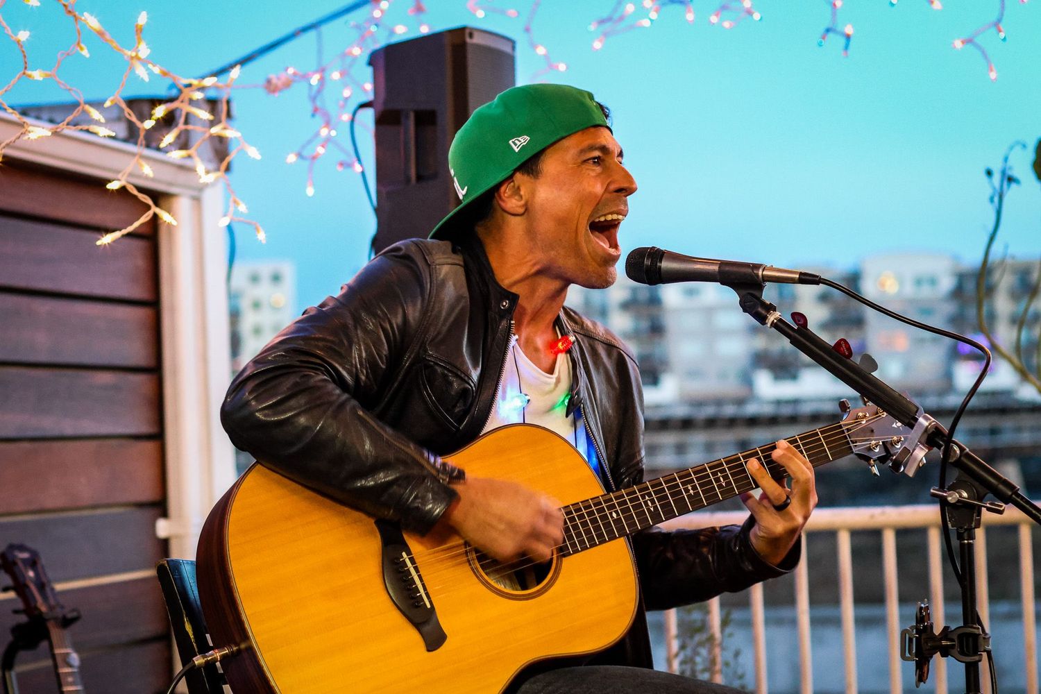 Oceanside live music photography of Kaleo Wassman of Pepper singing and playing acoustic guitar at Lighthouse Oceanside.