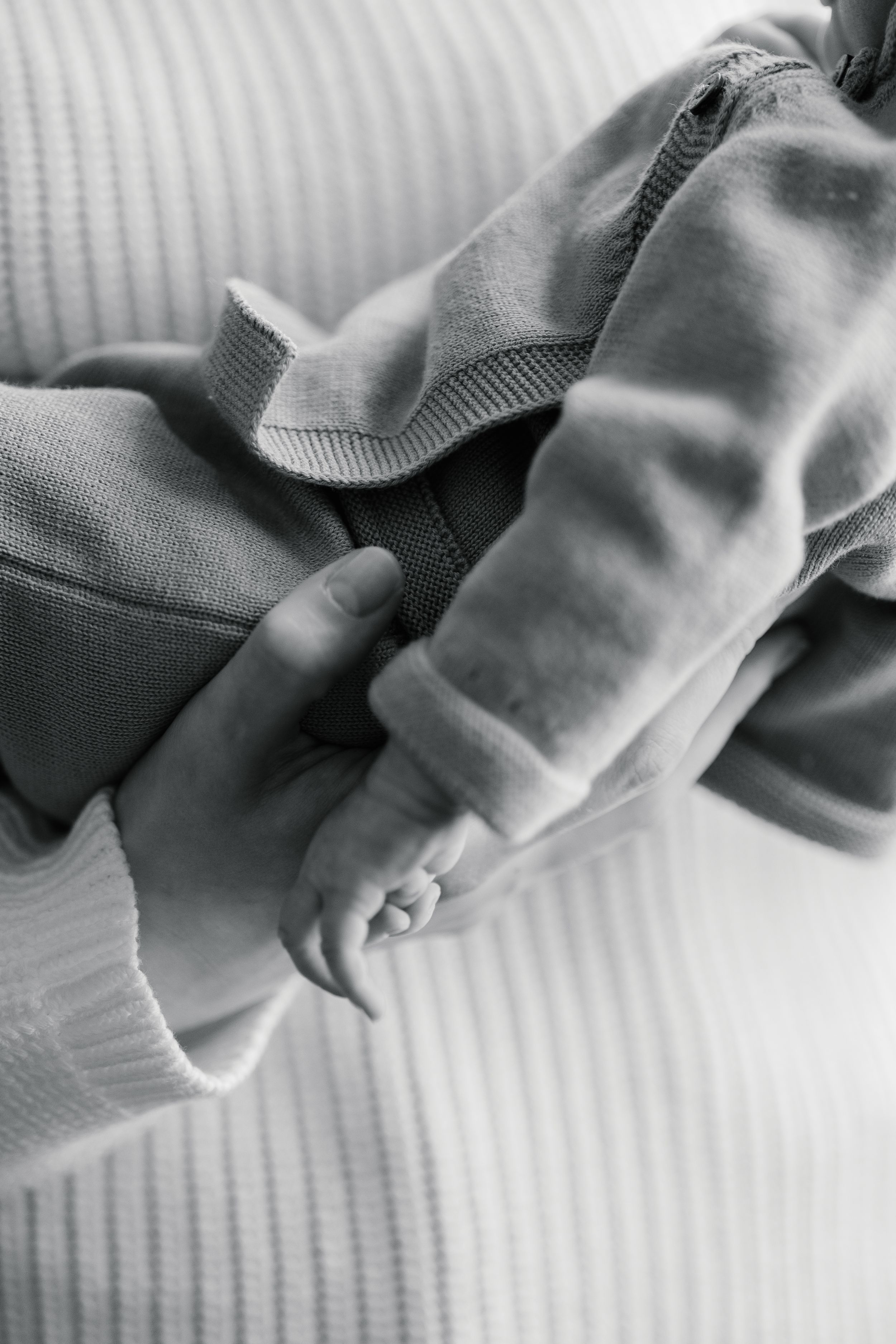 A series of black and white close-up photographs showing soft fabric textures and folds in grayscale tones.