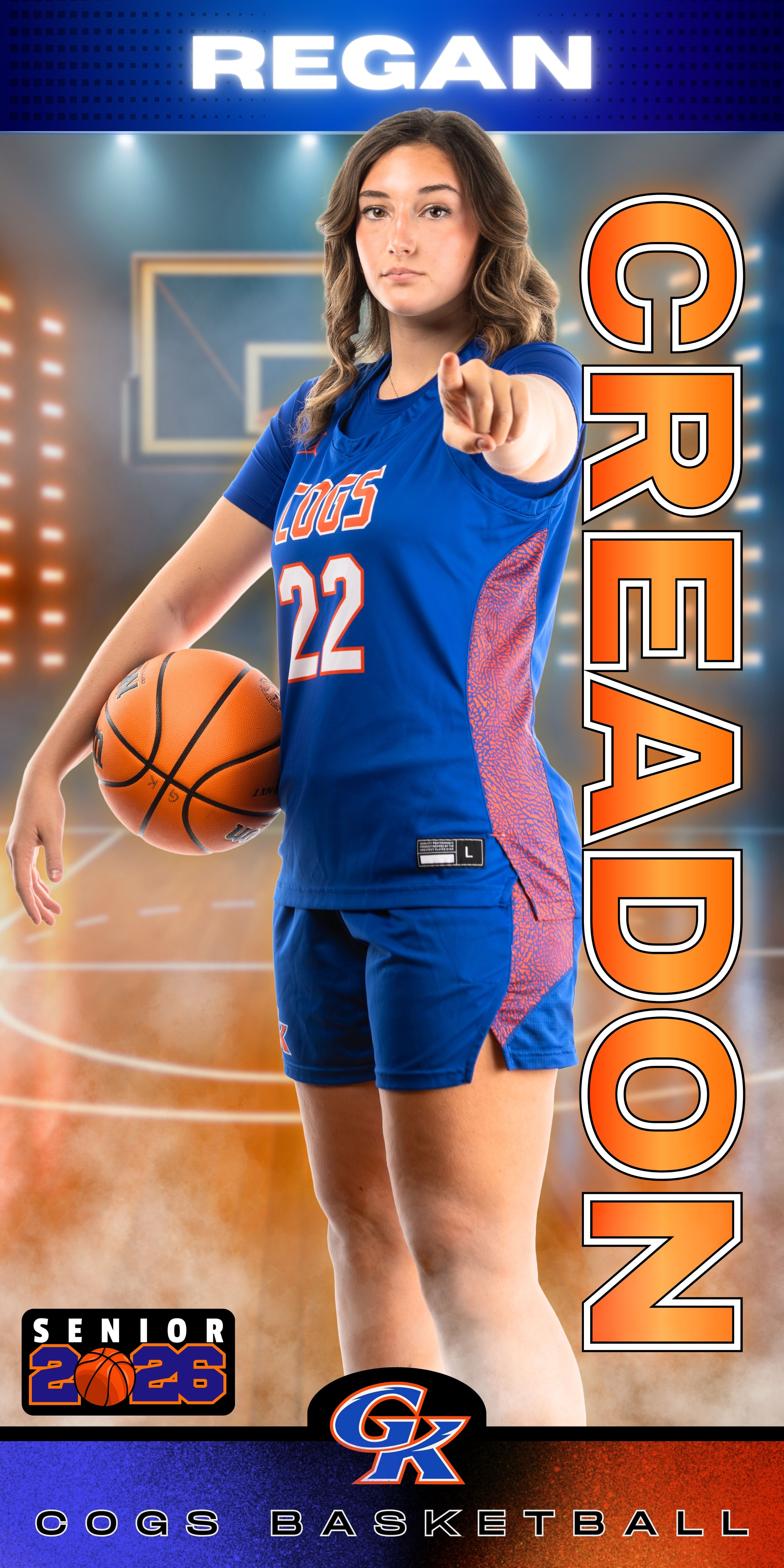 High school senior basketball player in blue uniform poses with ball in indoor court setting.