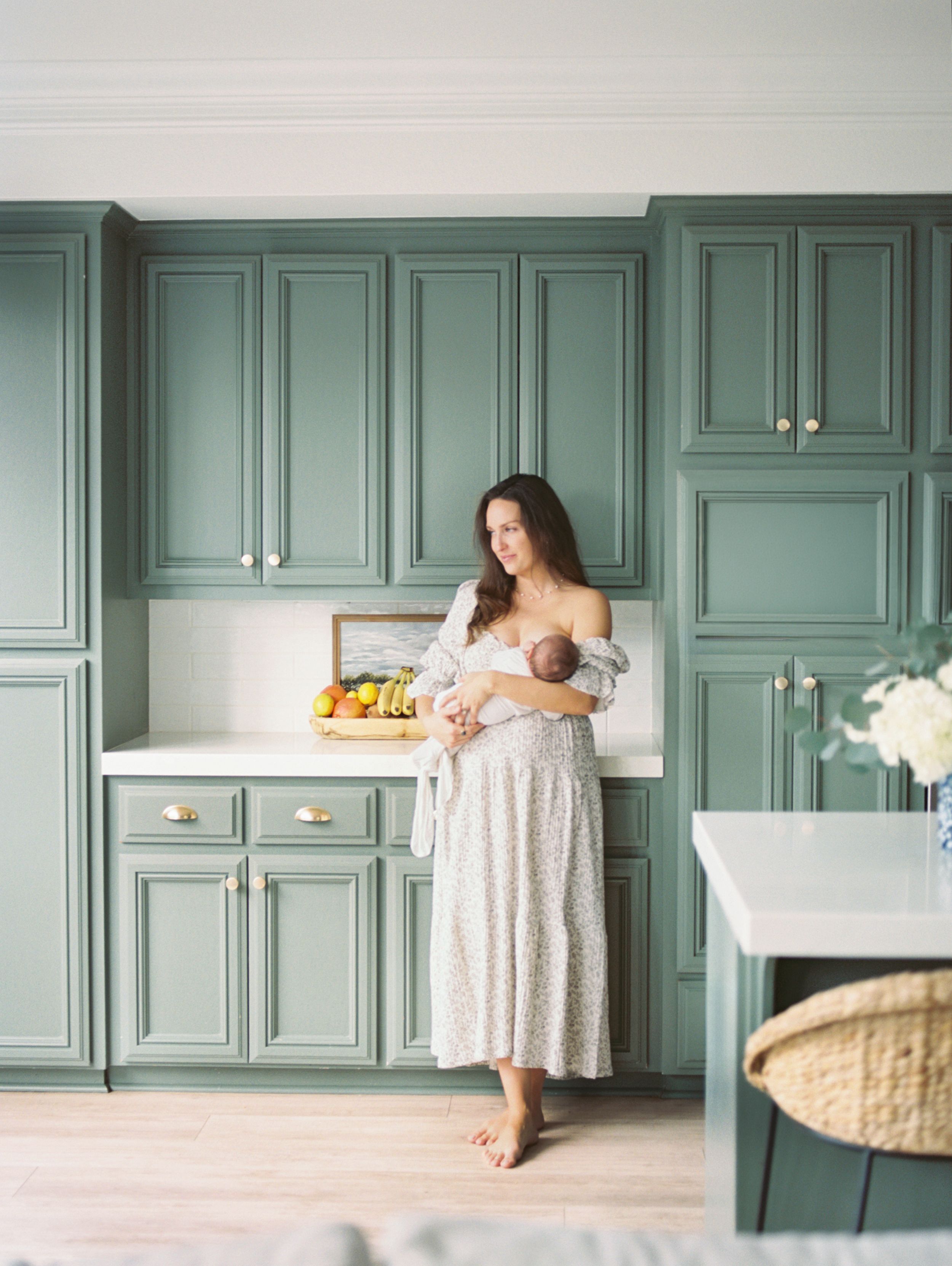 A series of five connected photos showing a baby on white countertops in a kitchen with sage green cabinets.