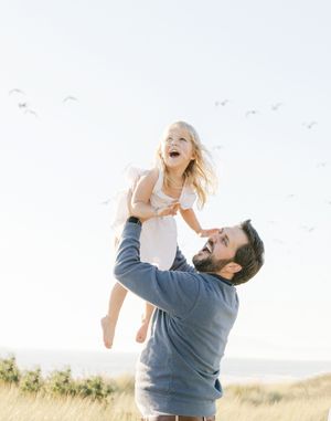Dad throwing little girl in the air trying to catch the birds from Chelsee Rawe Photography